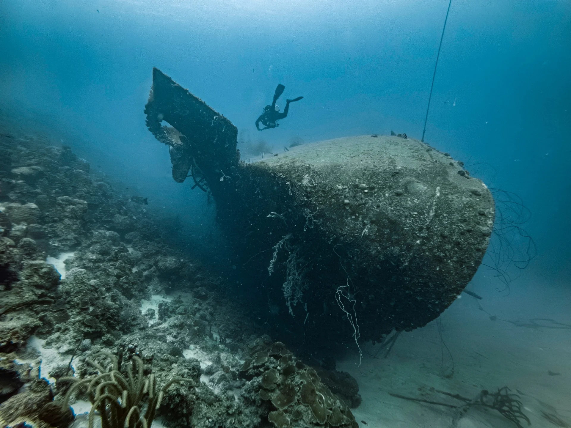 Diver exploring beside a shipwreck in Bonaire